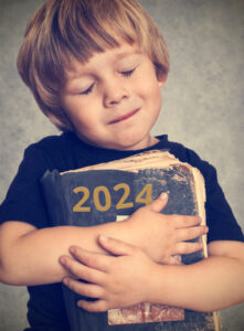 Little boy hugging a book